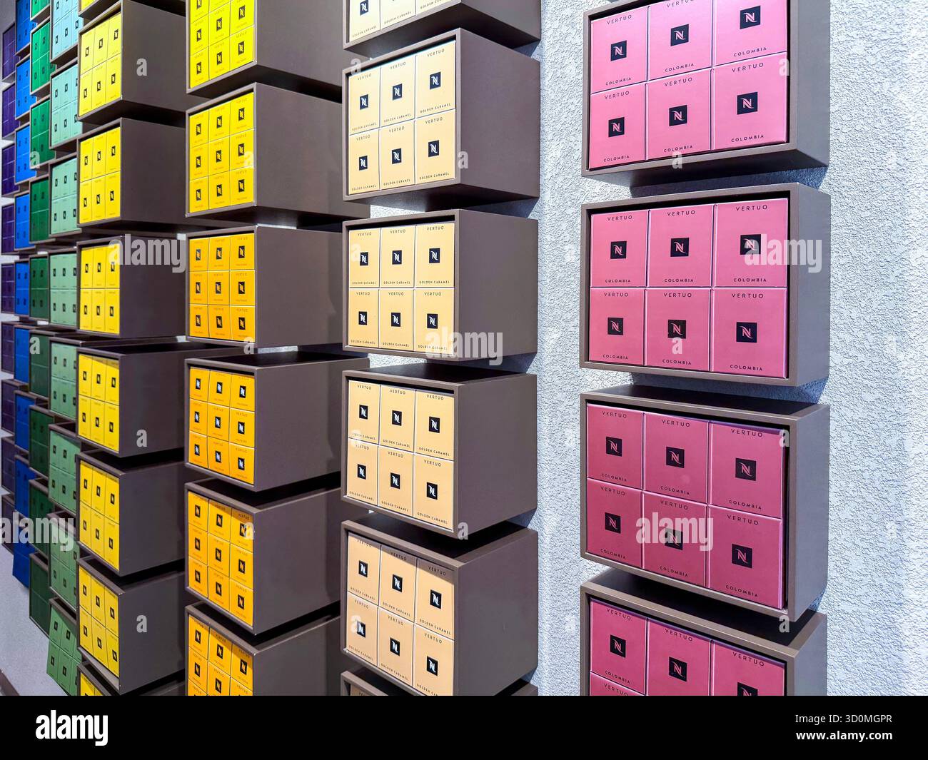 Colourful wall display of neatly arranged Nespresso coffee square boxes in  vertical rows creating a vibrant geometric pattern Palma Mallorca store - Smartphone Captured Stock Image