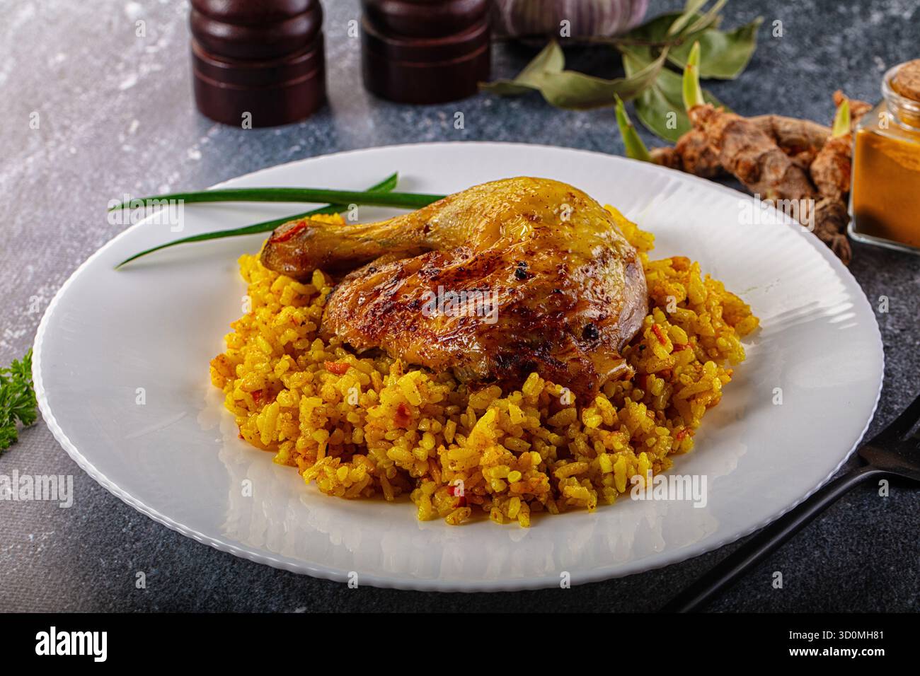 Roasted chicken leg with yellow curry rice Stock Photo - Alamy