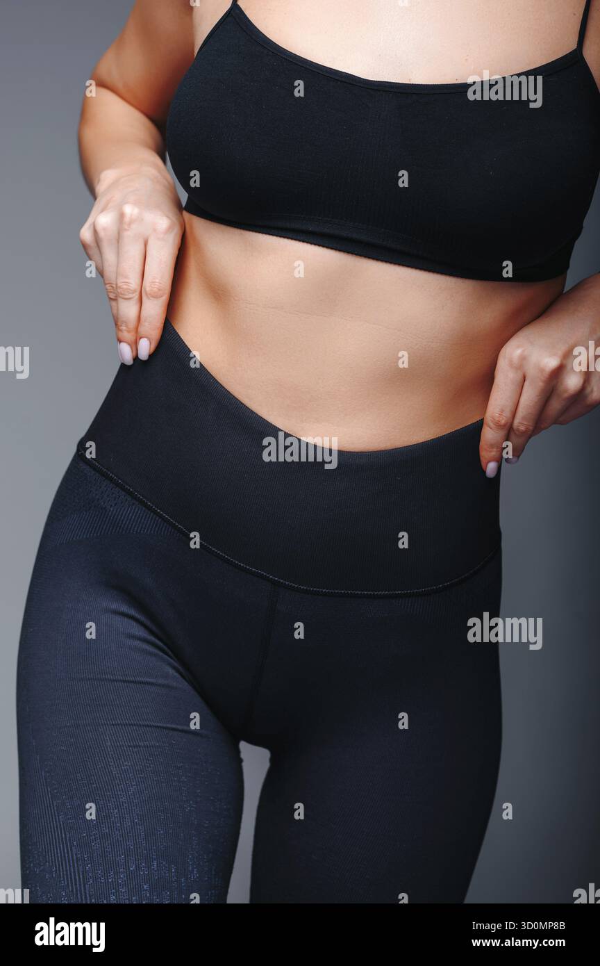 Close up view of female model posing at gray studio background Stock Photo