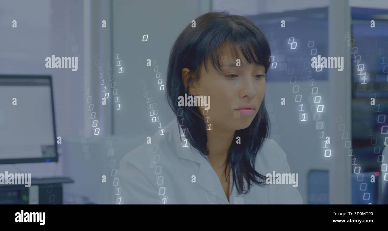 Asian scientist in lab coat processing binary code in lab, with computer monitors and server rack Stock Photo