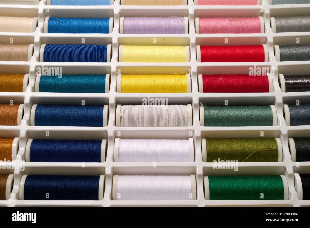 spools of multicolored sewing thread. Top view Stock Photo