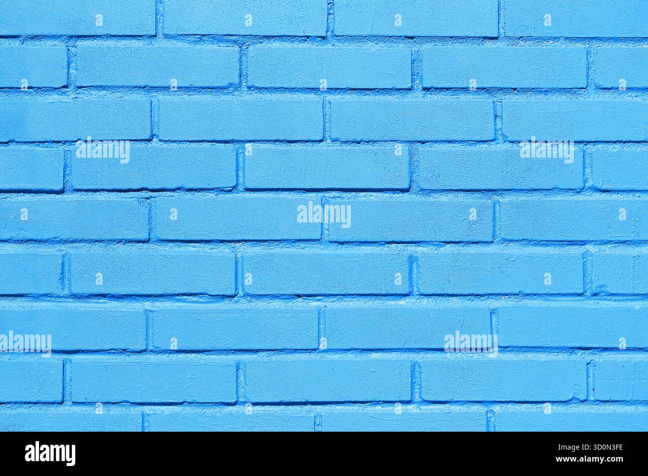 Blue painted brick wall texture background. Clean masonry surface with visible bricks. Urban architectural pattern for design use. Stock Photo