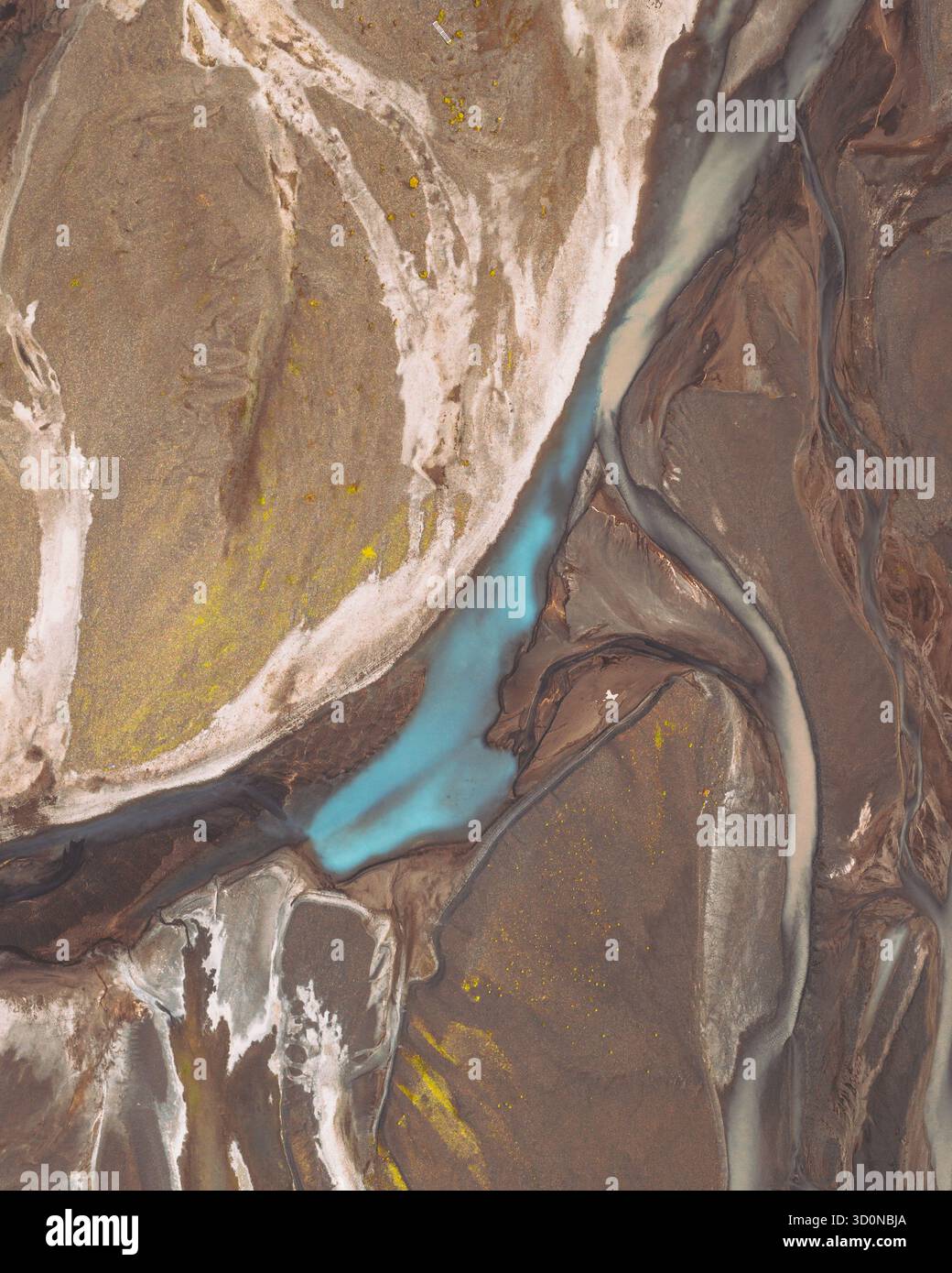 Aerial view of glacial streams carve through the stark, brown landscape ...