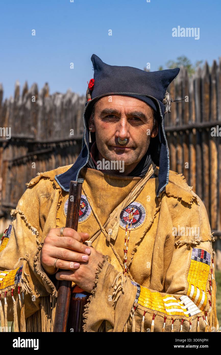 A man in period dress with a wolf ear cap at the Fort Bridger Historic ...
