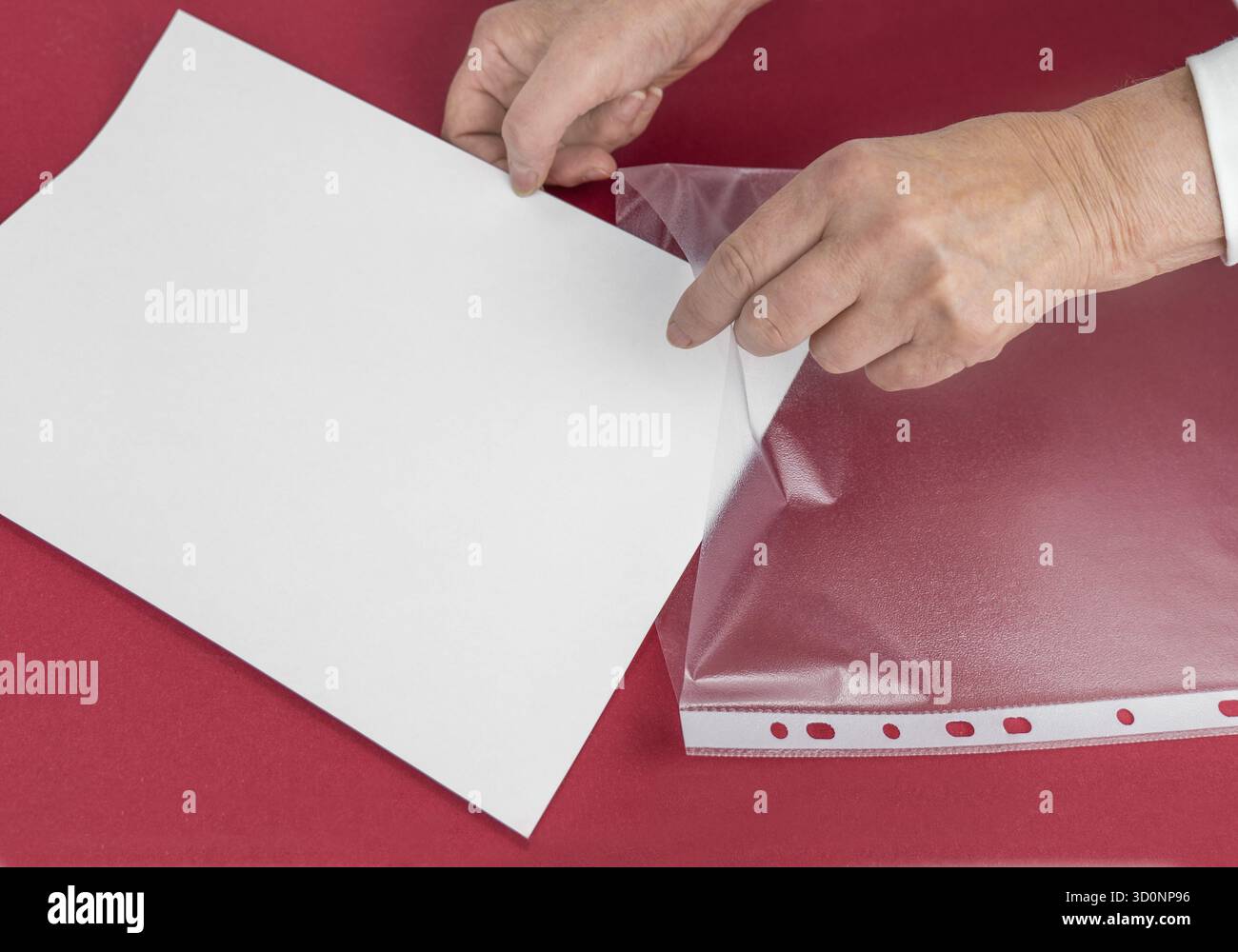 Put your document in the plastic sleeve. Saving and protection concept Stock Photo