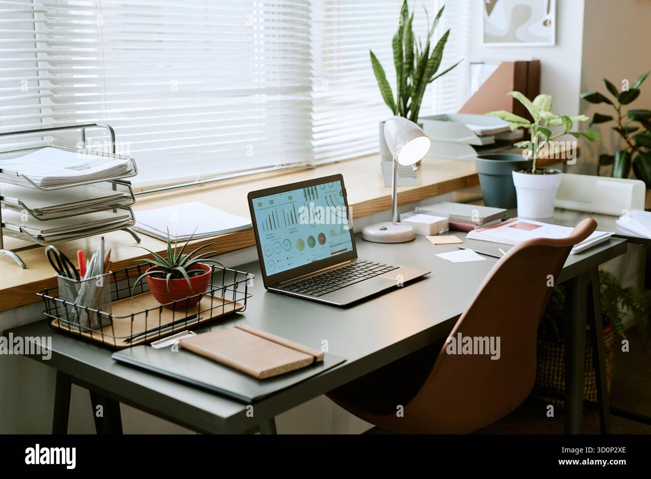 Modern Home Office Desk Featuring Laptop Displaying Business Analytics ...