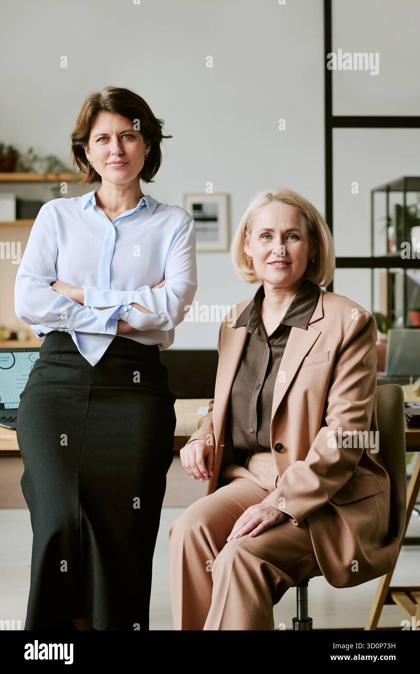 Middle Aged Women Collaborating in Modern Office Environment Stock Photo
