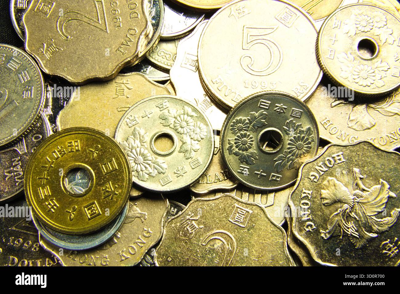 Close-up photo of a variety of Asian coins, some with unique floral ...
