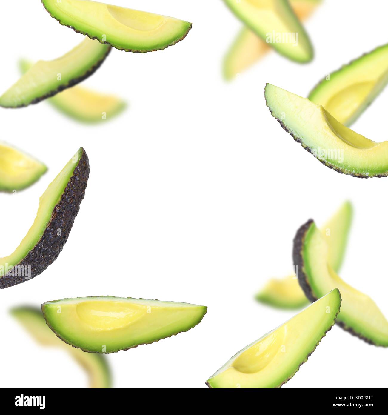 Fresh avocado slices falling on white background Stock Photo