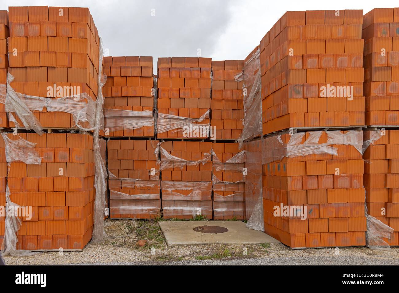 Orange Building Blocks at Stacked Pallets Construction Material Storage Stock Photo