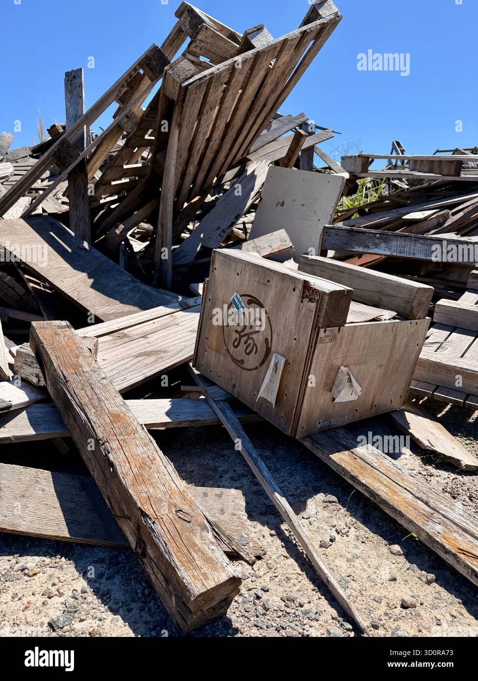 Pile of collapsed wooden debris under blue sky - Smartphone Captured Stock Image