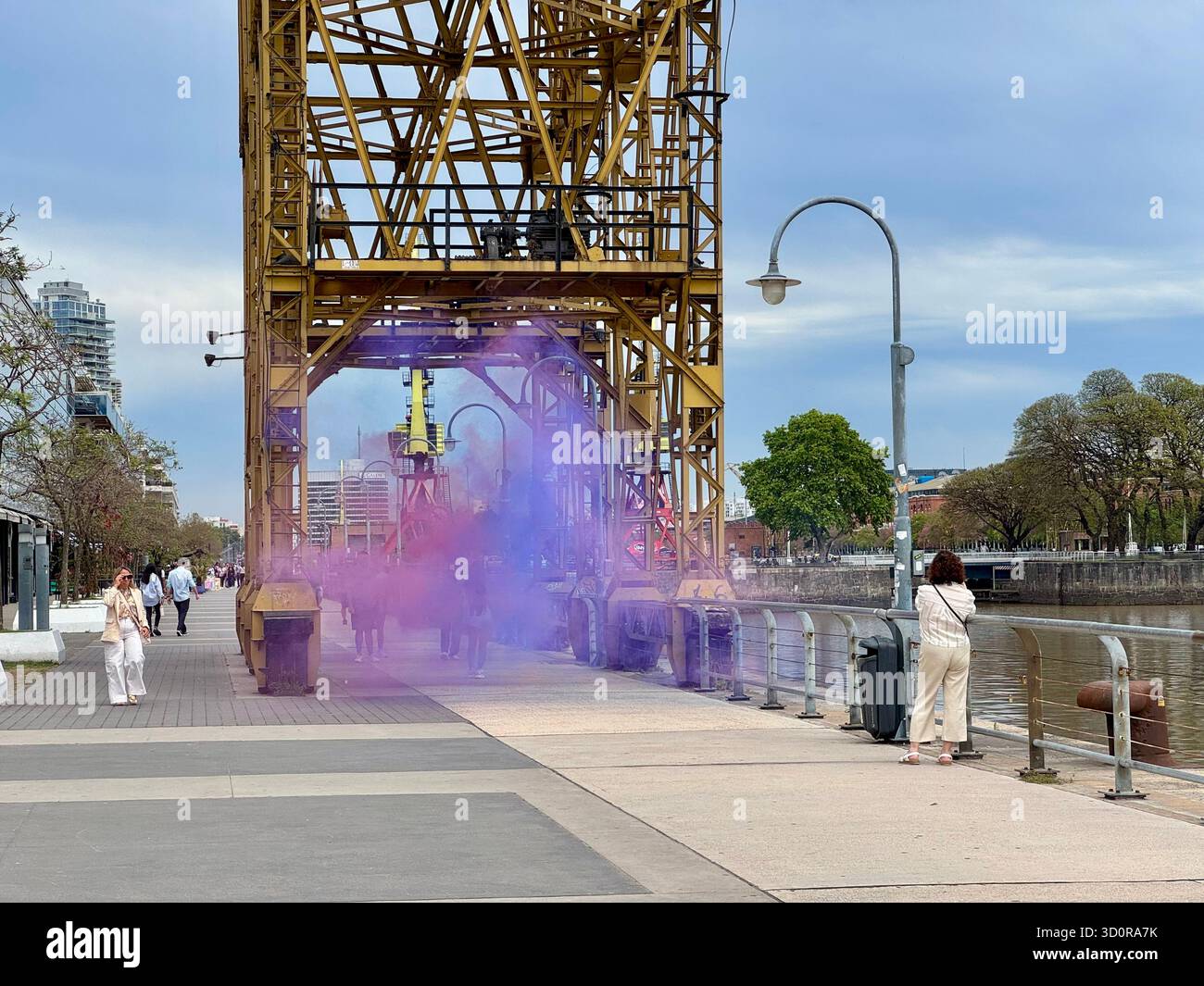 Colorful smoke art installation under old port crane in Puerto Madero, Buenos Aires - Smartphone Captured Stock Image