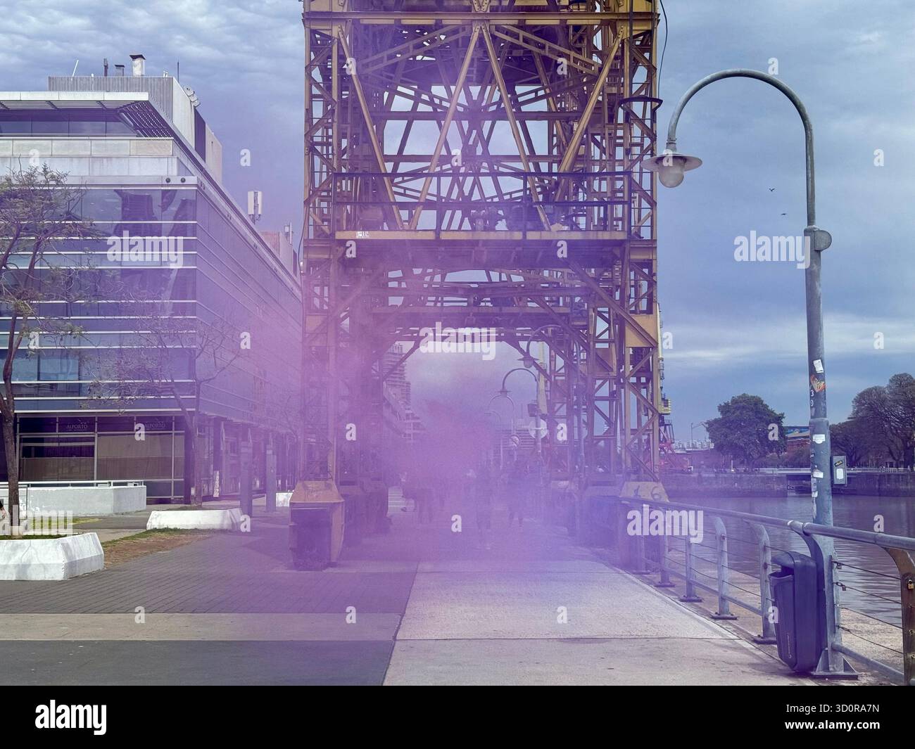 Colorful smoke art installation under old port crane in Puerto Madero, Buenos Aires - Smartphone Captured Stock Image