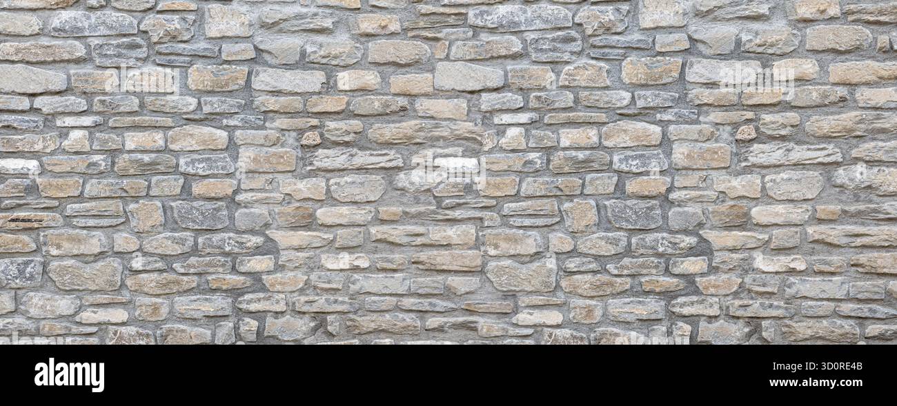 Stone wall showing irregular blocks creating a solid patterned background Stock Photo
