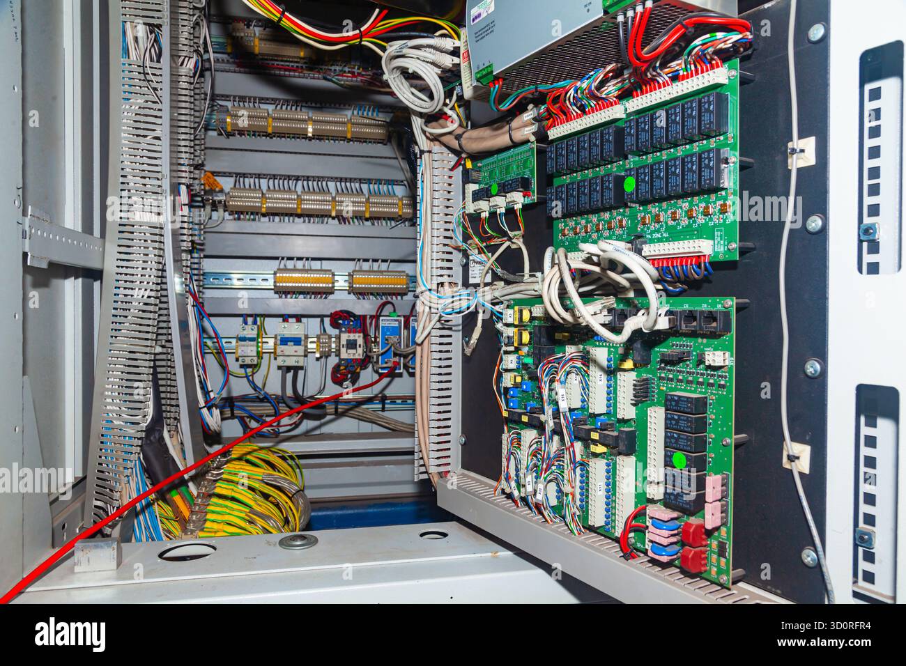 Server cabinet in the server room, with microchips and wires Stock Photo
