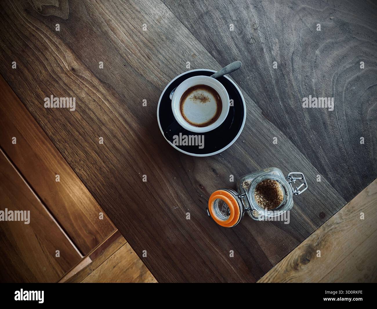 Macchiato coffee on the bench with sugar in a pot, empty table West Sussex, England - Smartphone Captured Stock Image