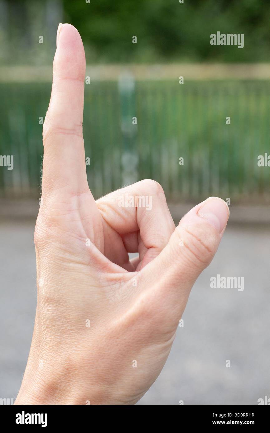 A closeup view of a hand skillfully making a detailed finger sign Stock Photo