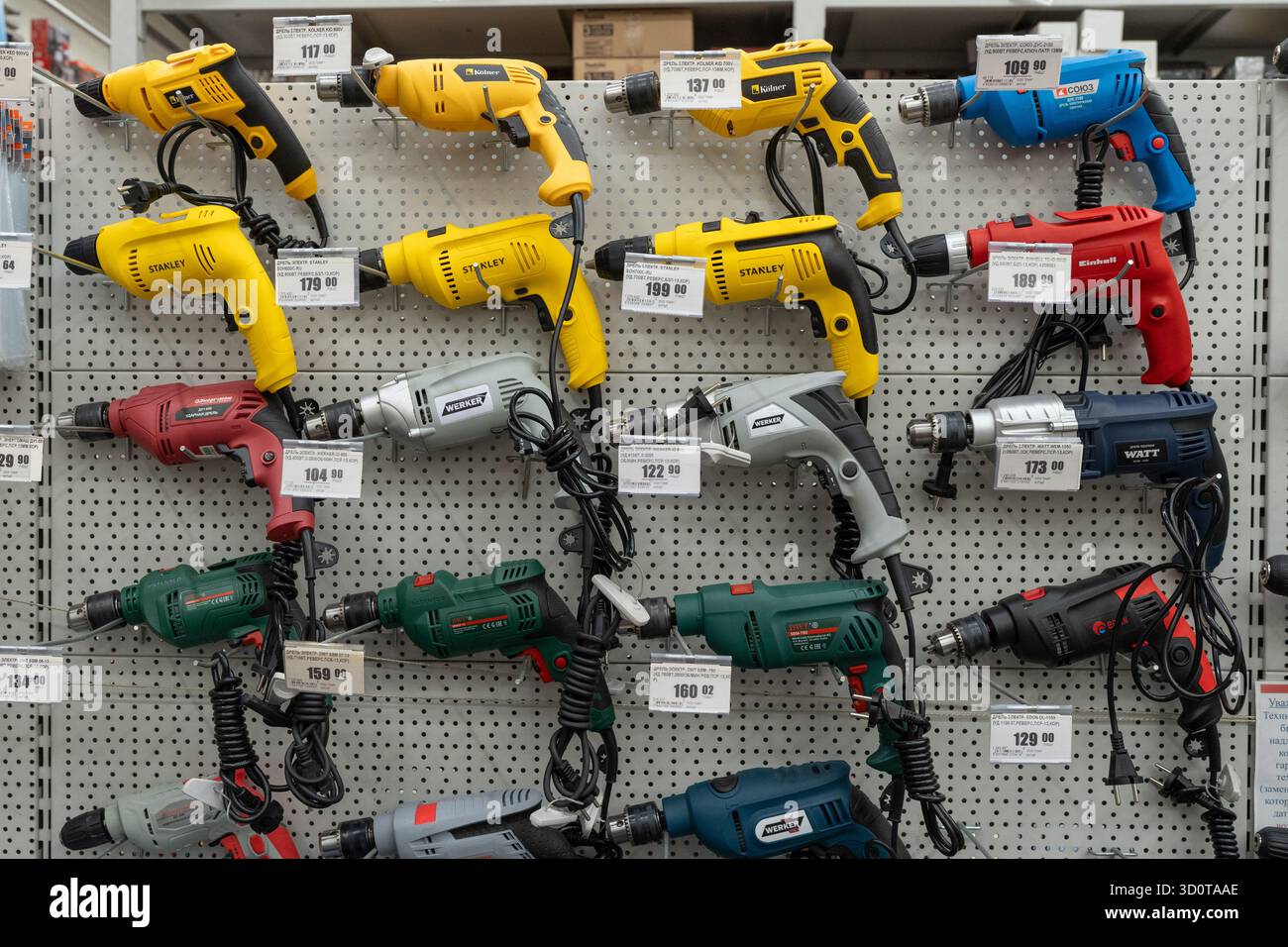 Electric drills and rotary hammers of various brands on display in the power tool store. Minsk, Belarus - july 5, 2025 Stock Photo