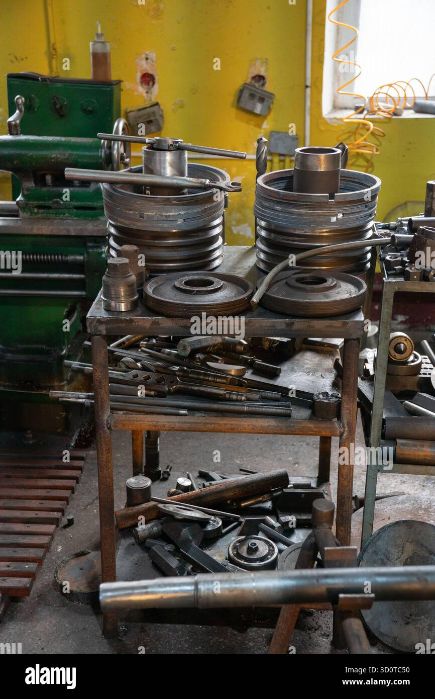 Train Engine Tools Metal flanges, couplings, and machining tools arranged on a workbench ...