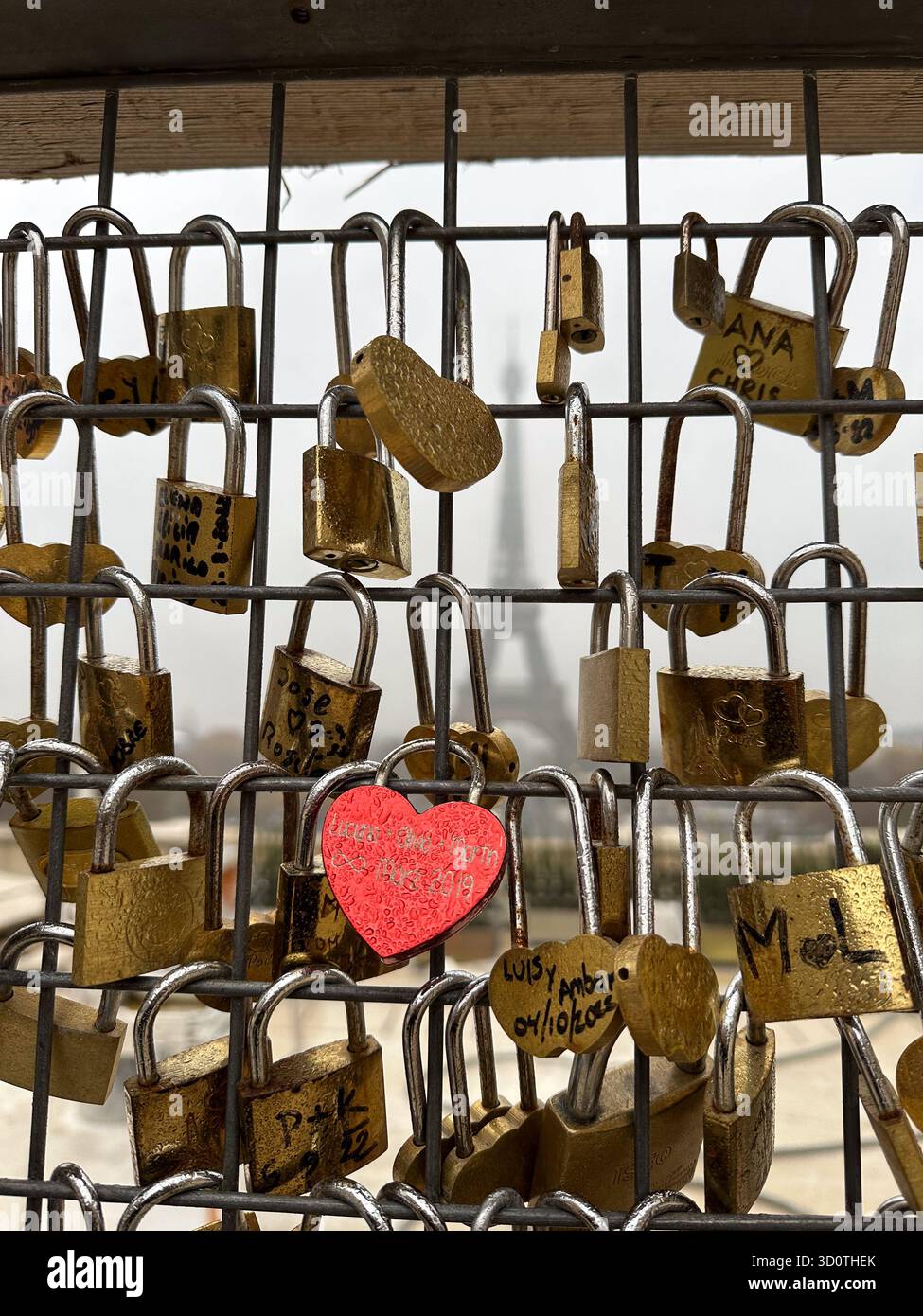 Love locks on the bridge with the blurred Eiffel tower in the distance, Paris, France - Smartphone Captured Stock Image