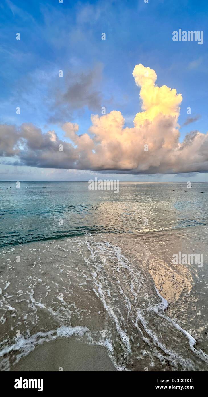 Tropical beach landscape with soft waves washing the shore under bright blue sky and fluffy clouds, Dominican Republic. - Smartphone Captured Stock Image