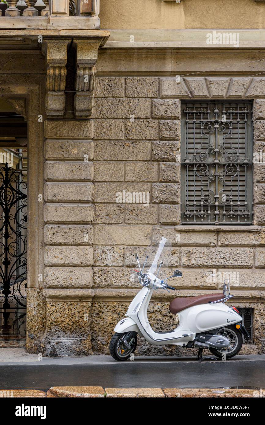 Piaggio Vespa Scooter parked in the old streets of Centro Storico, Milan, Italy Stock Photo