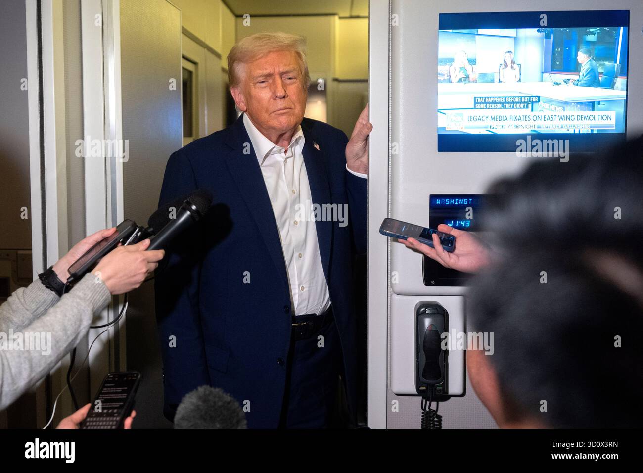 President Donald Trump speaks to reporters aboard Air Force One en ...