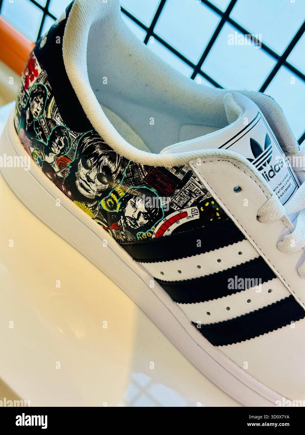 Oasis custom Adidas trainers - Smartphone Captured Stock Image