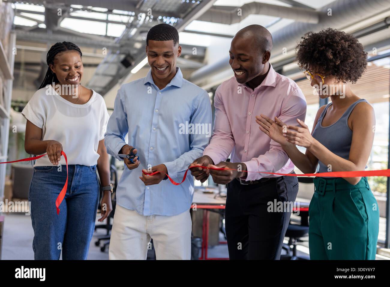 Diverse team celebrating office opening, cutting ribbon and smiling ...