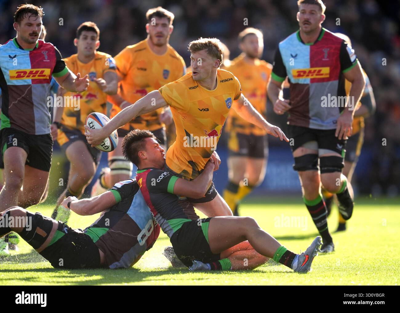 Newcastle Red Bulls' Alex Hearle (centre) is tackled by Harlequins ...