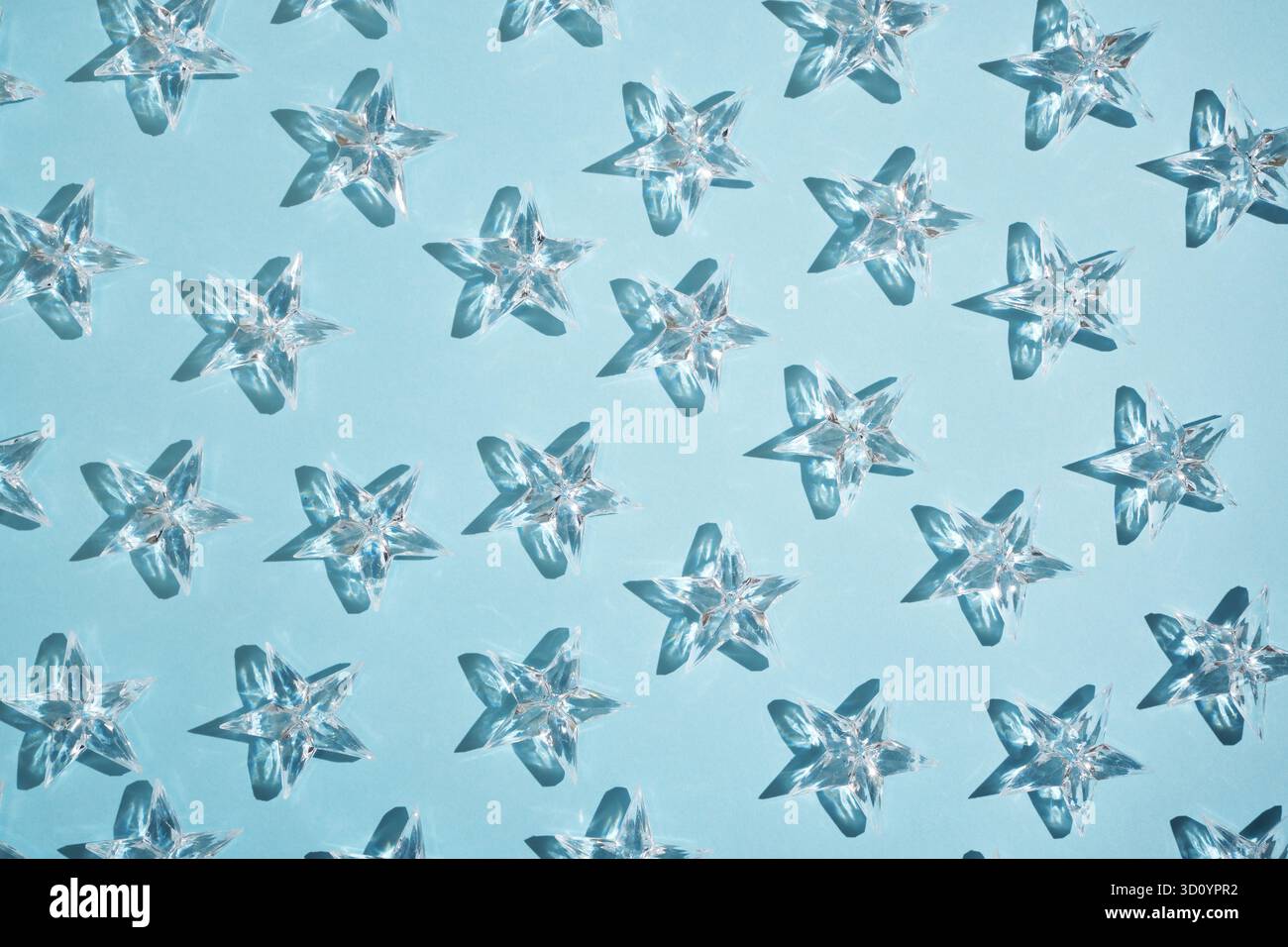 Pattern of transparent stars on a blue background. Stock Photo