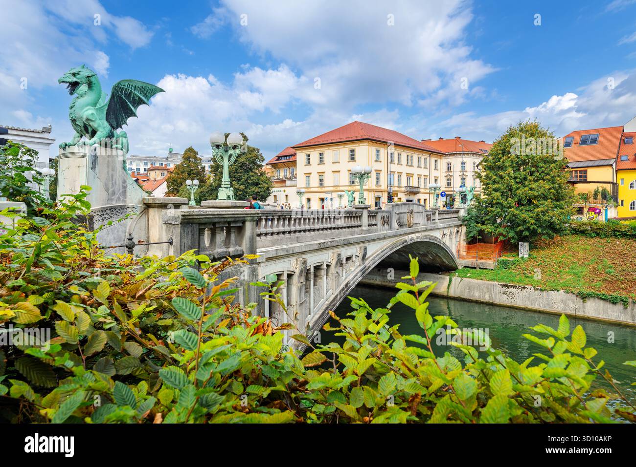 The pedestrian Dragon Bridge, or Zmajski Most, over the Ljubljanica River, in the historic old town center of Ljubljana, Slovenia at summer. Stock Photo