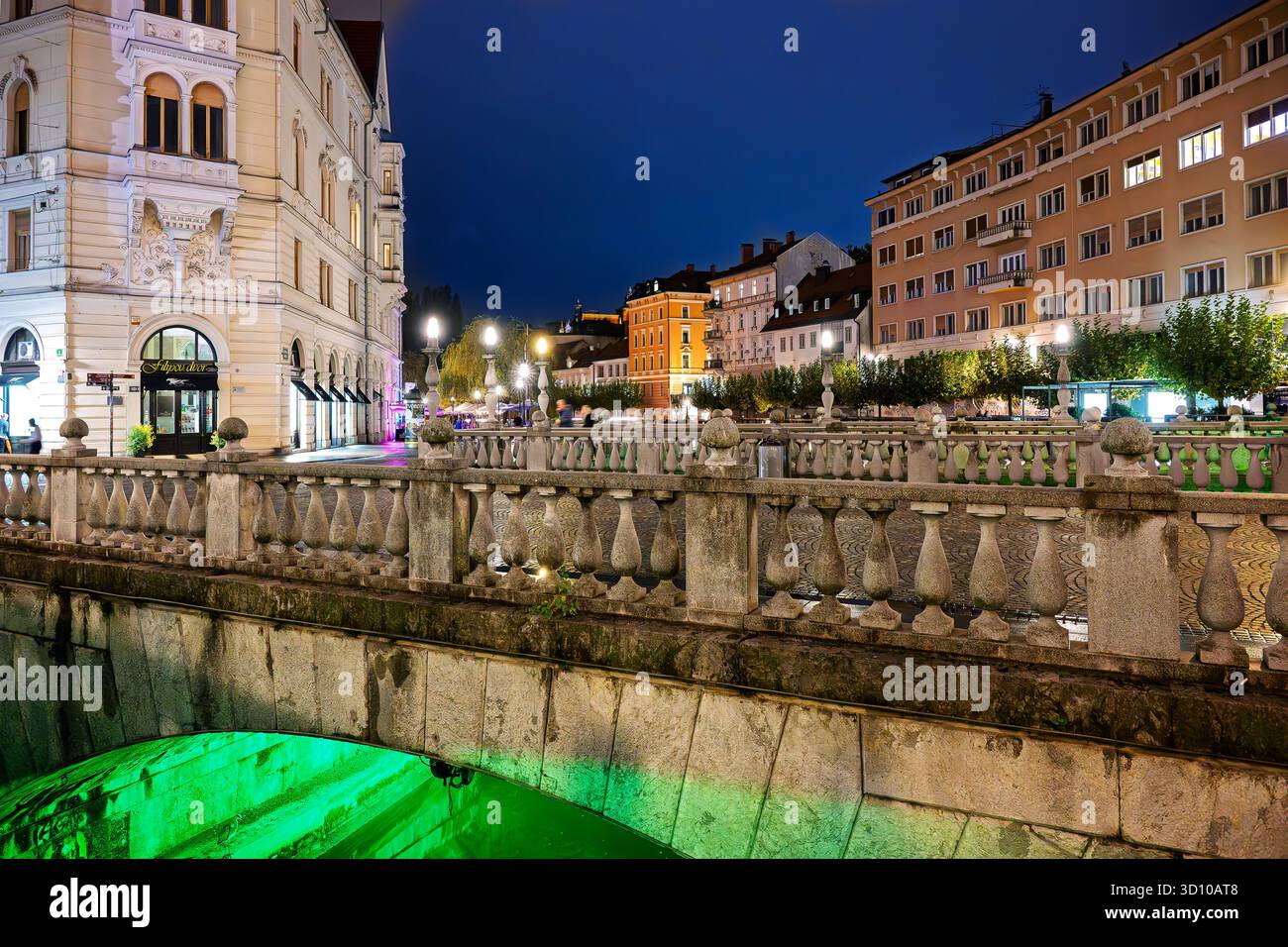 Night view of the 13th century Triple Bridge, three bridges that span the Ljubljanica River in the illuminated medieval old town of Ljublana, Slovenia Stock Photo