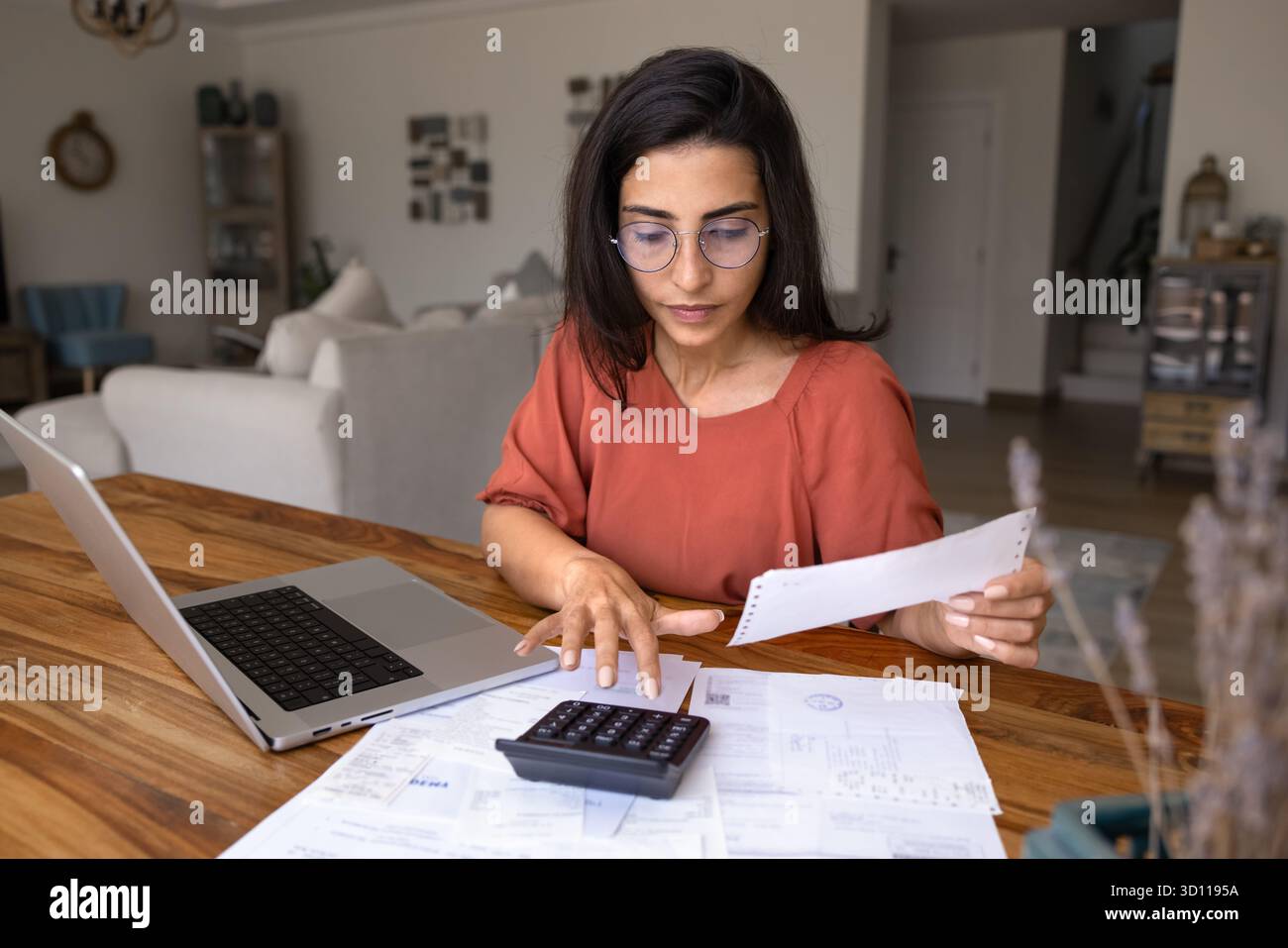 Focused young Latin freelance accountant working at home Stock Photo