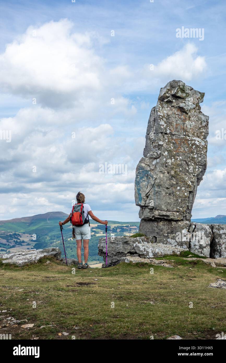 Woman backpacking walking past the Lonely Shepherd, a limestone pillar ...