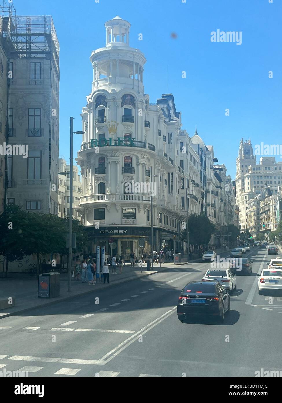View of the Rolex Building on Gran Vía in Madrid, Spain, with the Telefónica Building visible in the background on a sunny summer day. - Smartphone Captured Stock Image