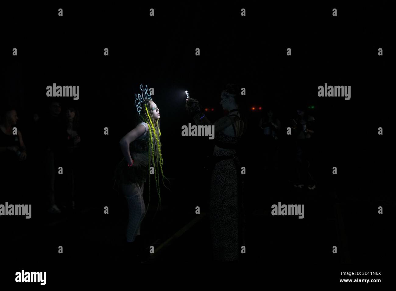 Medusa Rave A woman donning a medusa headpiece poses for a photo during a Halloween ...
