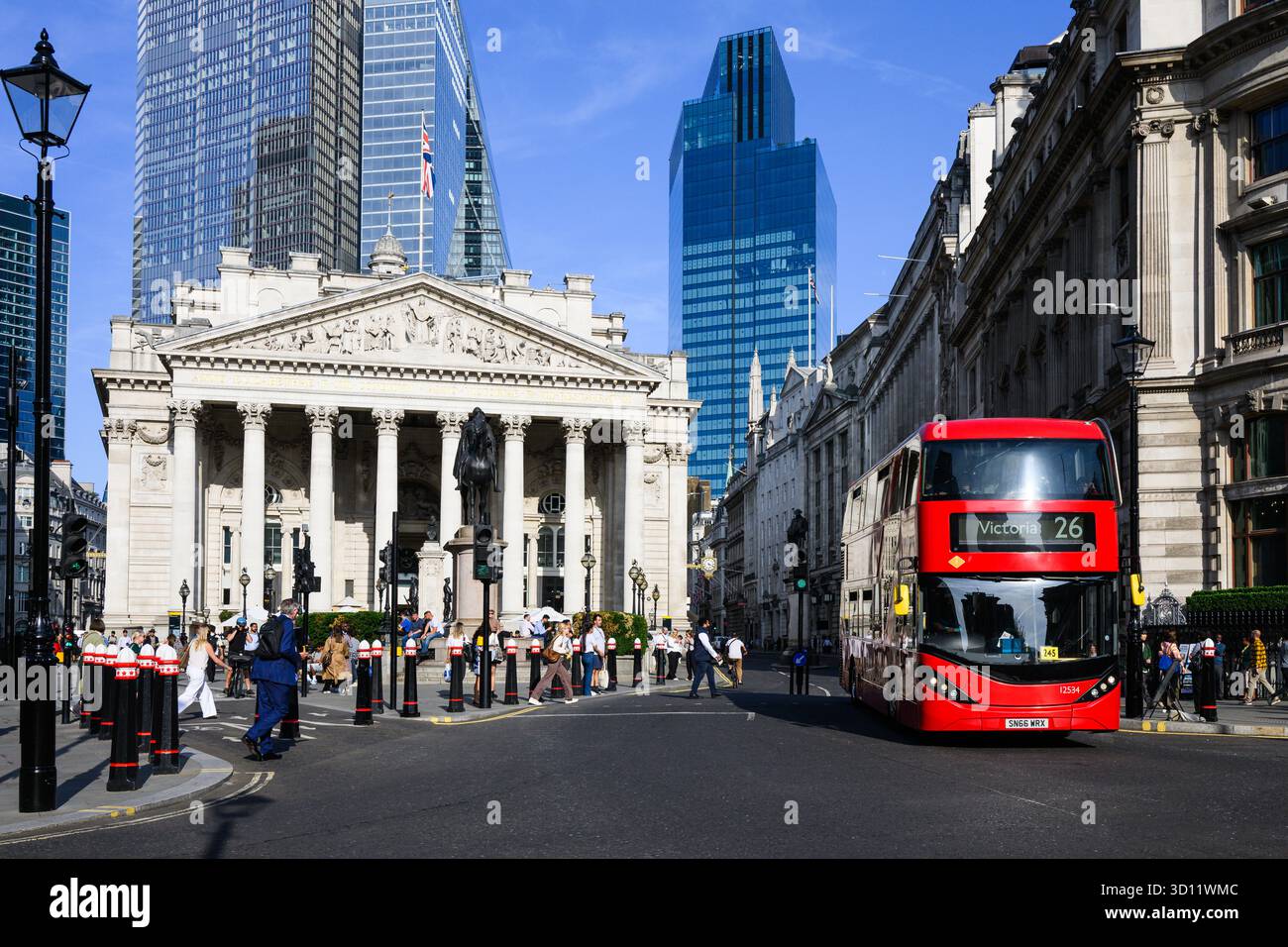 London, UK - August 20, 2025; London red double decker bus passing The Royal Exchange with skyline in City of London Stock Photo