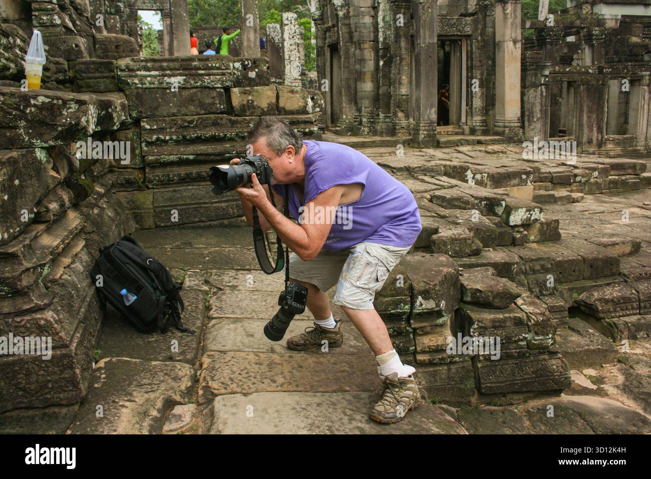 photographer Kraig Lieb in action at The Bayon Temple, Angkor Archaeological Park, Siem Reap Province, Cambodia. © Brooks Lieb Stock Photo