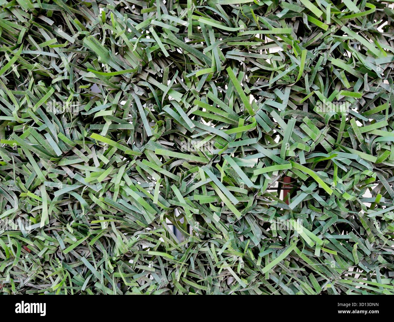 Green artificial grass fence close-up texture Stock Photo