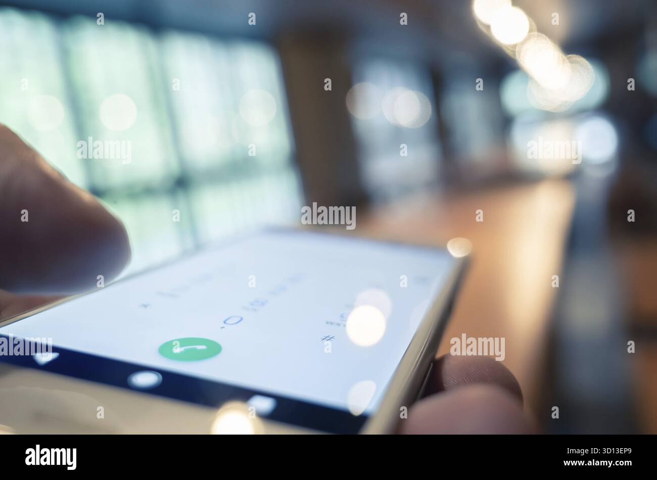 Using cellphone to dial, closeup image focus on the button Stock Photo