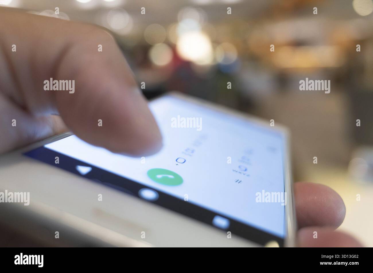 Using cellphone to dial, closeup image focus on the button Stock Photo