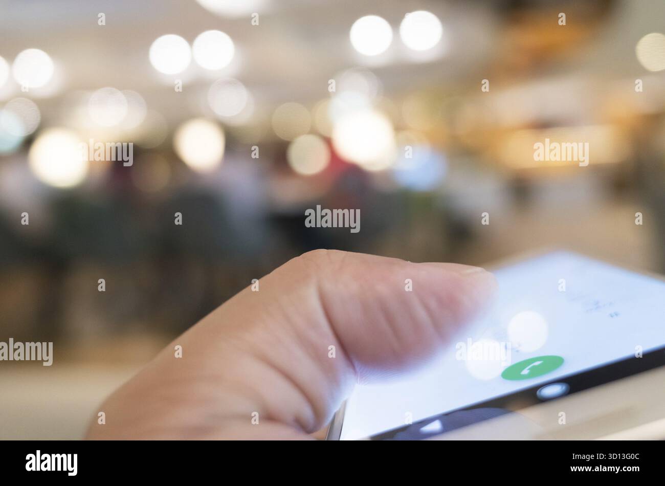 Using cellphone to dial, closeup image focus on the button Stock Photo