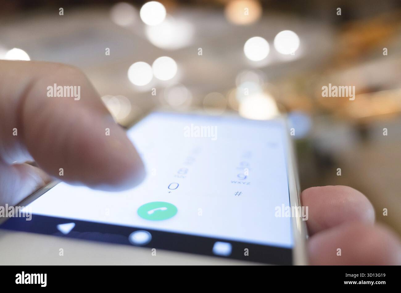 Using cellphone to dial, closeup image focus on the button Stock Photo