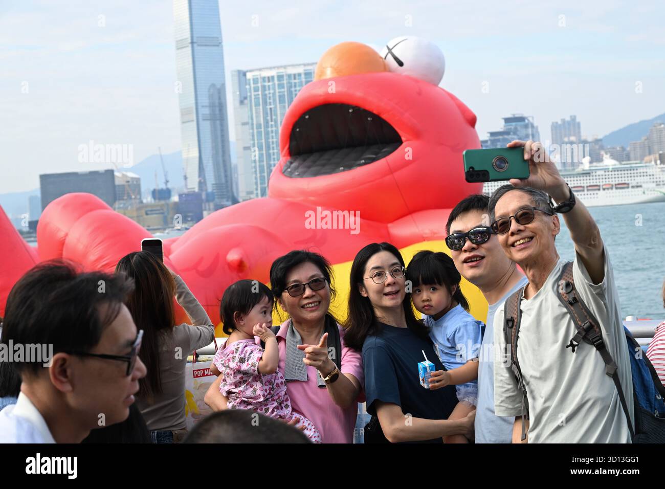 People selfie with Elmo, a floating inflatable sculpture at the “Water ...
