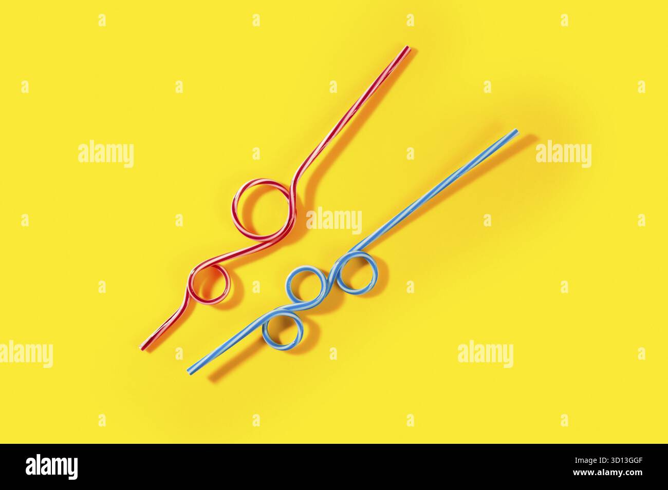 Plastic cocktail straws on yellow background Stock Photo