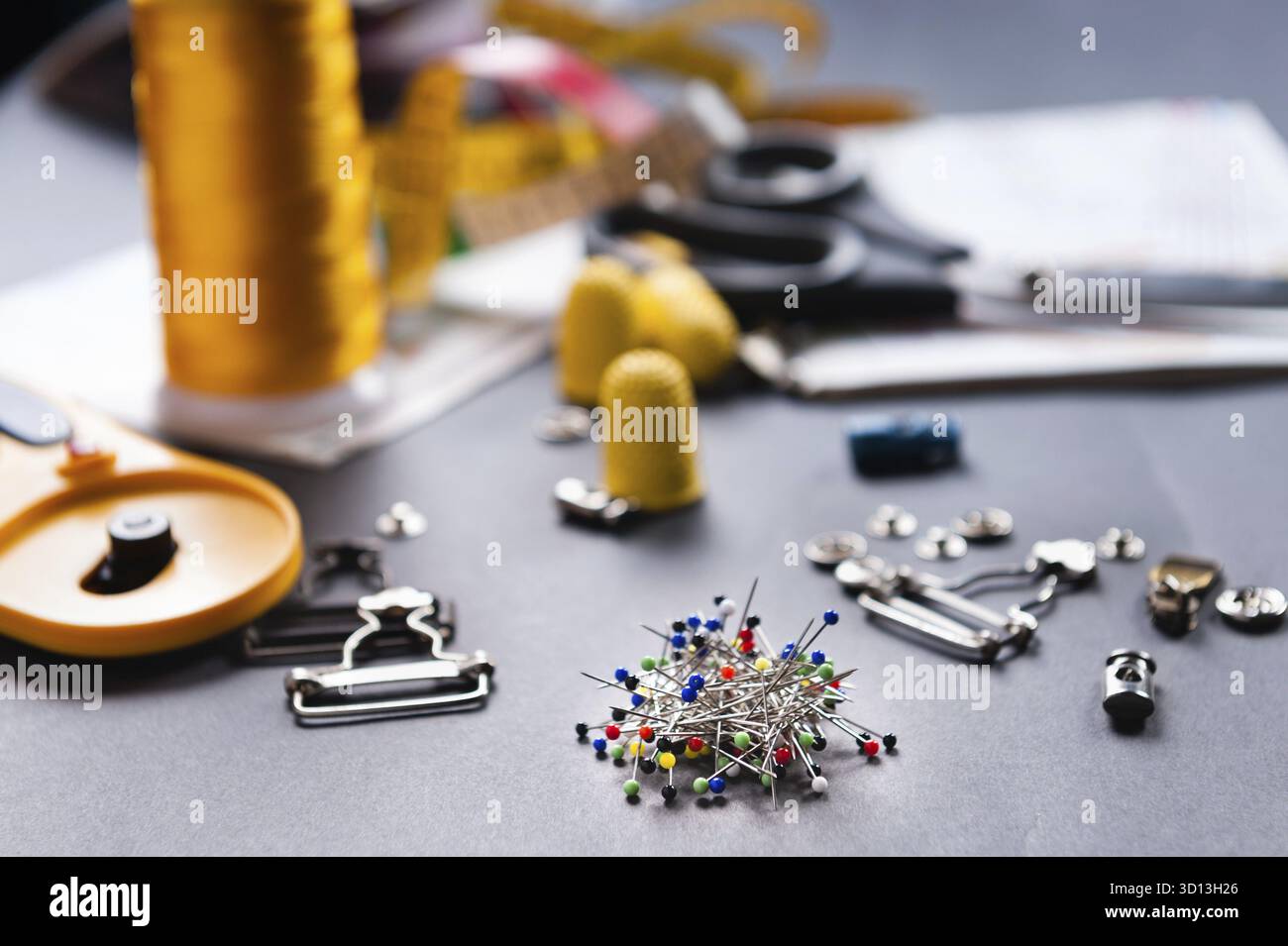 Thimble and sewing pins on dark backdround Stock Photo