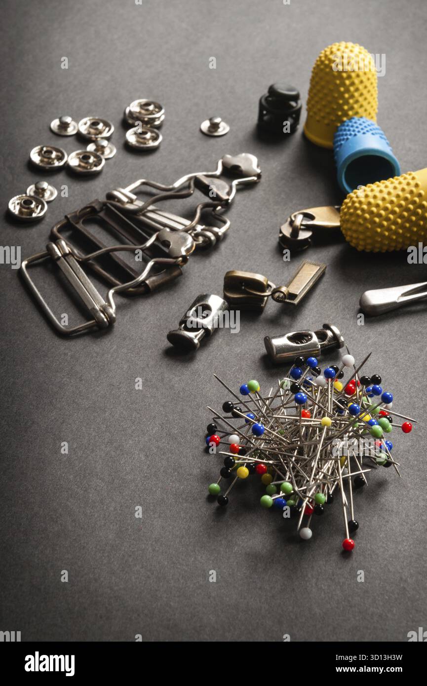 Thimble and sewing pins on dark backdround Stock Photo