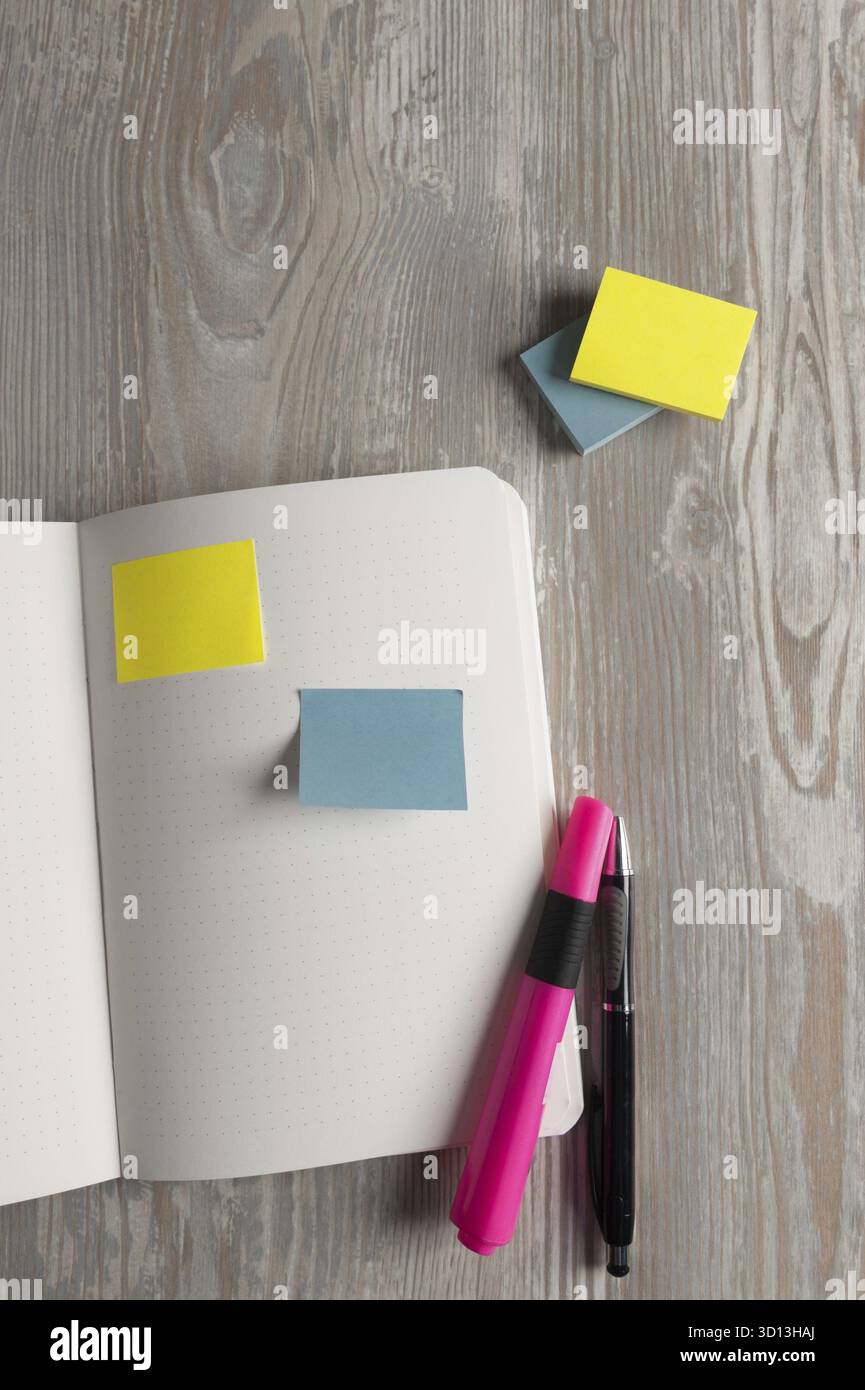 Notebook with pen and sticky notes on wood table Stock Photo