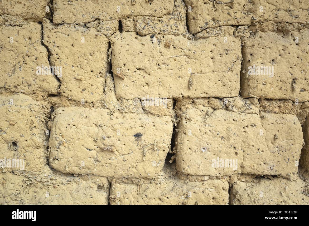 Old yellow mud brick wall background with good texture Stock Photo